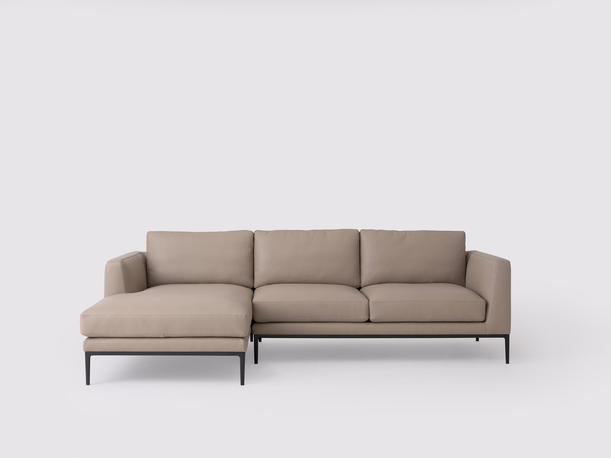 Front view of the Oma modern sectional couch in grey leather with left hand chaise